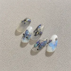 Macro detail of laser butterfly nail stickers with 3D beads on translucent base