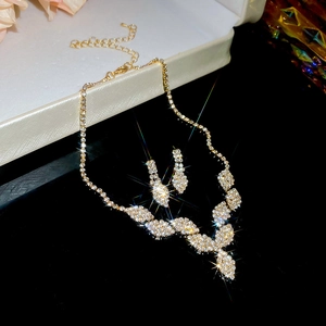 Detail of elegant gold-tone necklace and earrings set with sparkling rhinestones