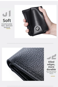 Detail of soft black pebble grain leather wallet showing flexible texture and durable edges