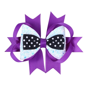 Detail of multi-layered Halloween hair clip with purple ribbon and black polka dot bow