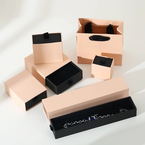 Detail of light pink drawer jewelry boxes and matching paper gift bags set