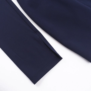 Detail shot of navy blue dress showing high-quality fabric texture and slit stitching