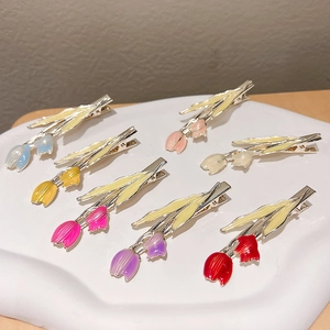 Colorful tulip flower hair clips set in varied oil-dripped finishes on a display plate