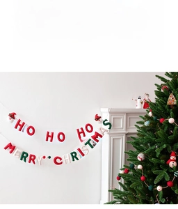 Christmas bunting with Merry Christmas and Ho Ho Ho text hanging by a tree on a white wall