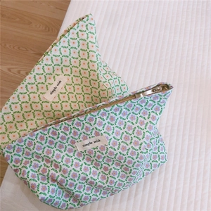 Detailed close-up of floral cotton pouches with zipper and 'simple wish' fabric label