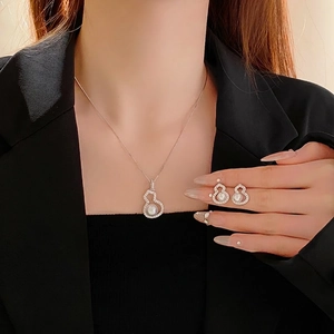 Elegant zircon gourd and pearl jewelry set with necklace and earrings on a model