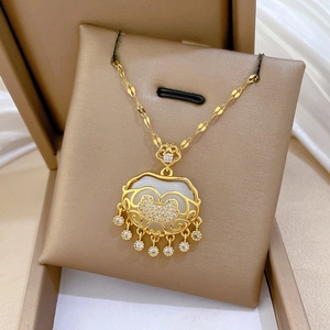 Detailed shot of a gold tassel lock necklace with white jade and shimmering crystals
