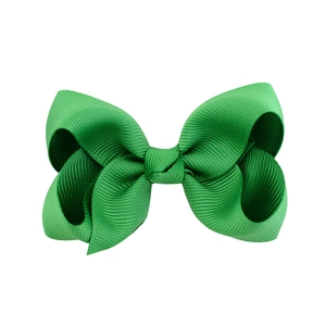 Detail of a bright green grosgrain ribbon bow with high-quality ribbed texture and finish