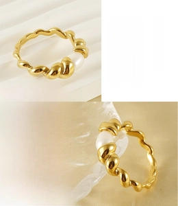 Close-up of 18k gold plated braided ring featuring a natural white pearl accent