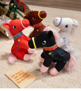 Detail of colorful plush zodiac horse toys with floral embroidery on soft white carpet