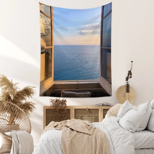 Detail of bohemian tapestry featuring a realistic ocean view through a rustic window