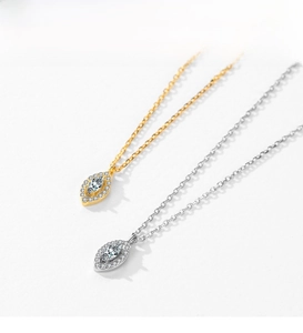Close-up of S925 sterling silver evil eye necklaces in gold and silver with marquise stones