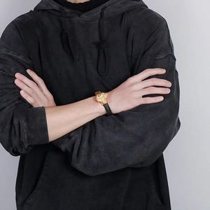 Men's braided black leather bracelet with a gold-finished lion head stainless steel clasp