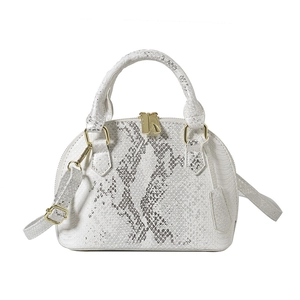White faux snakeshell seashell crossbody bag with golden hardware and adjustable strap