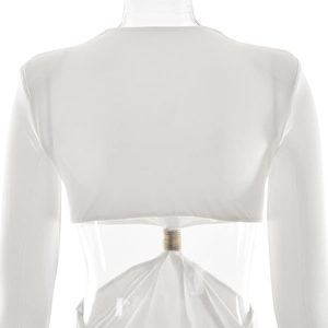 Detail of white long sleeve dress with back cutout and decorative gold metal ring