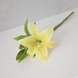 Macro detail of artificial yellow lily flower head with realistic petals and bud