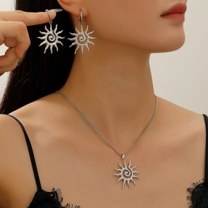 Detailed close-up of a silver sunflower necklace and earrings set worn by a model
