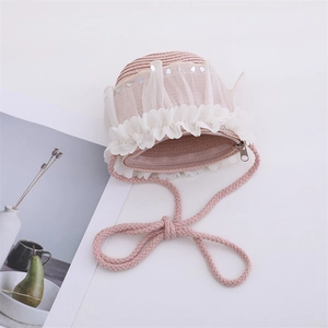 Pink woven straw crossbody bag for girls with white lace trim and silver sequins detail