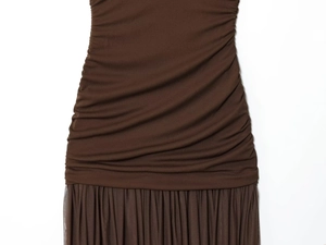 Detail of ruched knit bodice and pleated mesh skirt transition on a dark brown dress