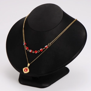 Double-layered gold stainless steel necklace featuring red evil eye beads and sun pendant