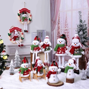 Charming plush Christmas snowman figurines with plaid hats for festive window display