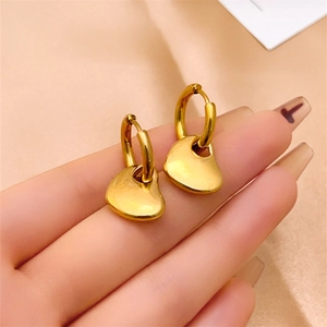 Minimalist 16K gold heart hoop earrings with fluid textured pendants on silk background