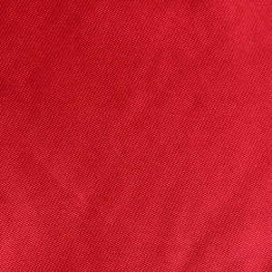 Macro view showing the detailed texture and fabric weave of the red evening dress