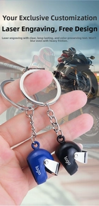 Close-up of blue and black 3D mini motorcycle helmet keychains with laser engraving details