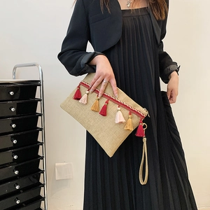 Bohemian woven straw clutch bag with colorful tassels and red embroidery strap