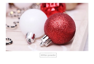 Macro shot of red glitter Christmas ball and white matte ornament with silver caps