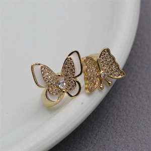 Detail of micro-paved zircon butterfly rings with colorful enamel on gold plated band