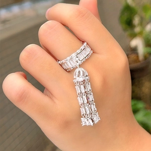 Detail of cubic zirconia tassel ring with sparkling rectangular crystals on hand