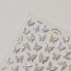Macro shot of iridescent butterfly nail stickers with shimmering shell-like effect