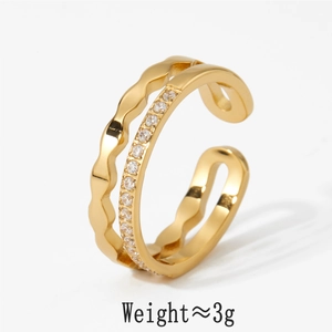 Macro shot of gold double-layer open ring with clear zircon inlay on white background