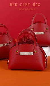 Detail of red leather gift bag with golden Sweet Love plaque and elegant mesh closure