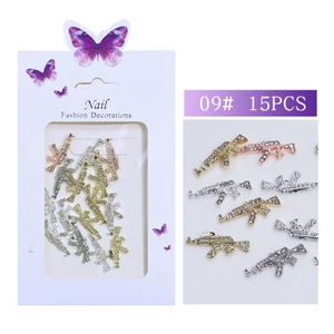 Detailed view of AK-47 shape nail art rhinestones on white professional packaging