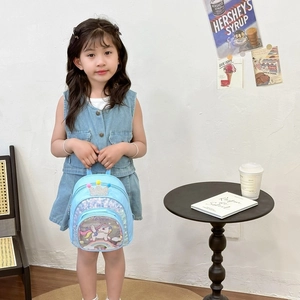 Sparkly blue unicorn backpack with sequins and crown for little girls in home setting