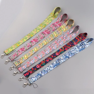 Detail of colorful floral polyester lanyards with metal lobster clasps and black cord loops