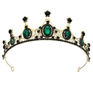 Detailed macro view of baroque gold bridal crown featuring green gems and black crystals