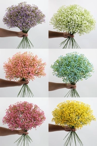 Six different colors of artificial baby's breath bouquets held against a plain white background