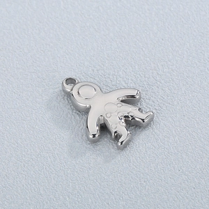 Macro shot of silver gingerbread boy pendant with smooth polished stainless steel finish