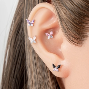 Cute butterfly stud earrings with colorful crystals on ear model in polished silver steel
