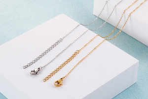Detail of stainless steel O-link necklace chains in gold and silver with lobster clasp