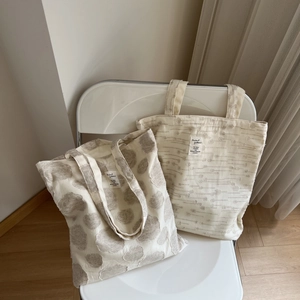 Detailed macro view of textured cotton linen tote bags with 3D dots and striped patterns