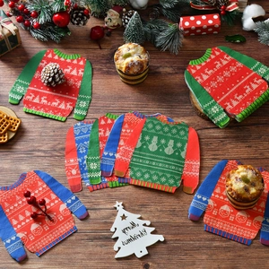 Detail of Christmas sweater shaped paper napkins with reindeer and snowflake patterns