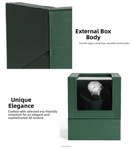 Detail of dark green leather watch winder box with white stitching and display window