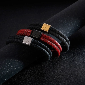 Detail of multi-layer braided leather bracelets with nautical anchor metal clasps
