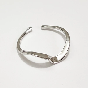 Minimalist 925 sterling silver Mobius ring with wavy texture on white background