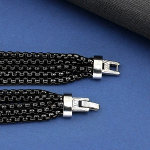 Macro detail of four-strand black box chain bracelet with silver polished metal buckle