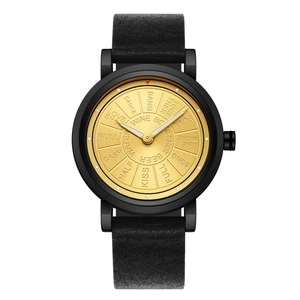 Macro shot of black leather strap and gold dial with stylized text on quartz watch